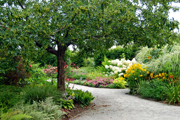 a path runs among lush flower beds