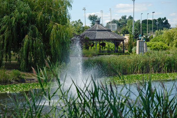 a view across the pond fountain to the gazebo