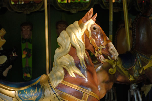 a horse with a blond mane on the antique carousel